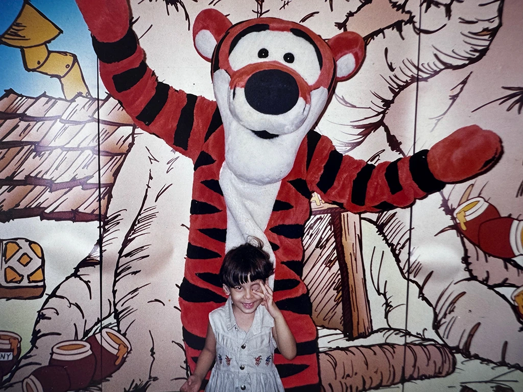Laura posando de niña con un tiger, personaje de Winnie Pooh.