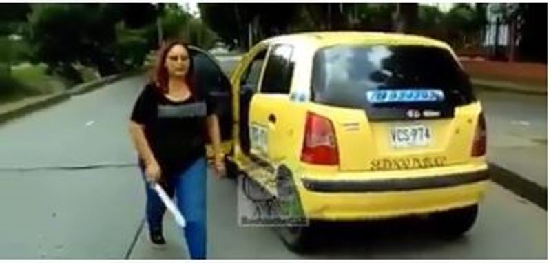 En video: mujer taxista agredió con un machete a un motociclista en Cali